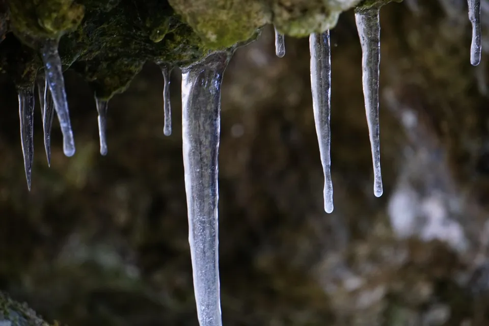Icicles hanging from a frozen ledge in winter